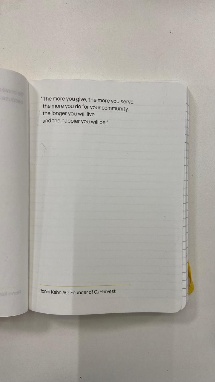 Open book with a quote on a plain background