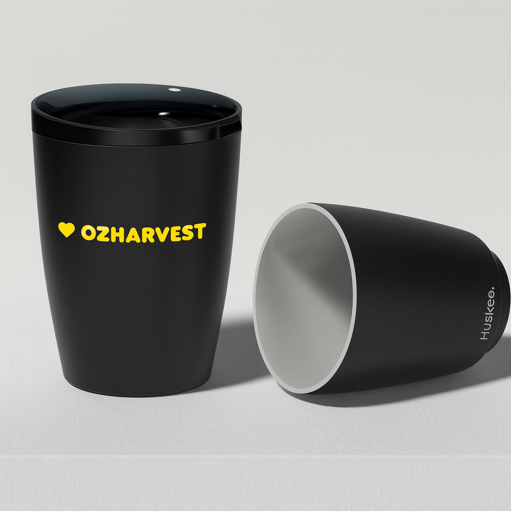 Black tumbler with yellow text 'O2Harvest' on a light gray background