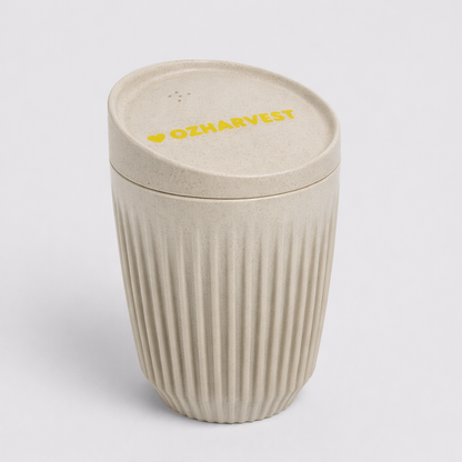 Beige textured tumbler with lid featuring 'OZHarvest' branding on a light gray background