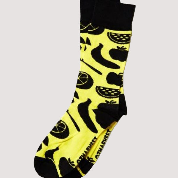 A pair of yellow and black socks with food item patterns and the OzHarvest logo.