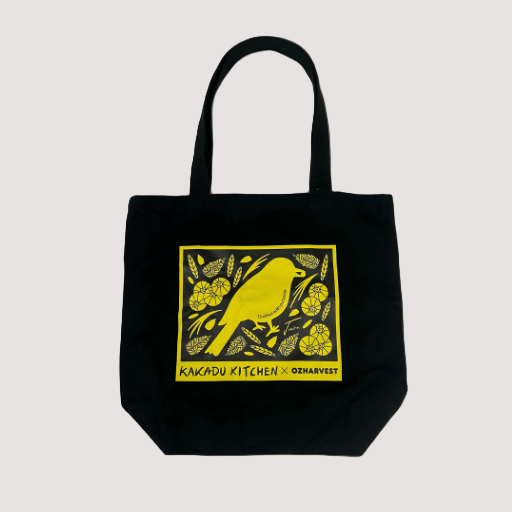 Black tote bag with a yellow logo on a white background