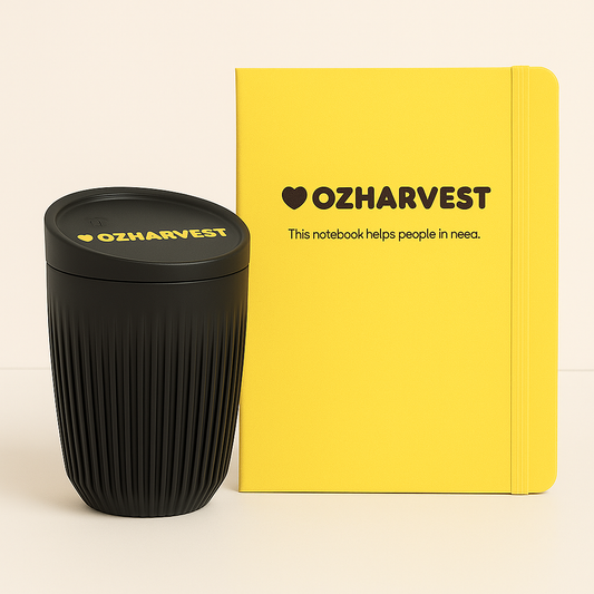Black coffee cup and yellow notebook with 'OZHarvest' branding on a beige background
