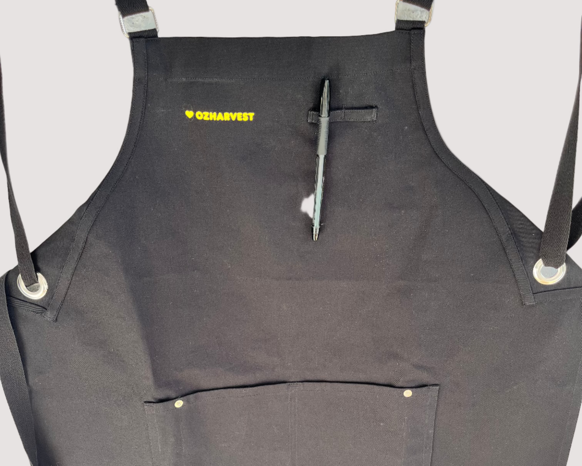 Black apron with a pen on a light gray background
