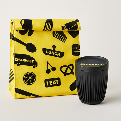 Yellow lunch bag with black patterns and a black reusable cup on a light gray background