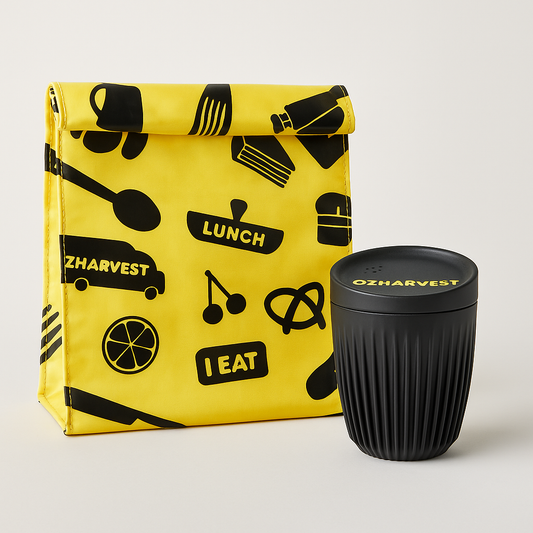 Yellow lunch bag with black patterns and a black reusable cup on a light gray background