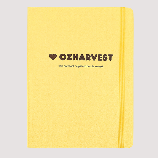 Yellow notebook with OzHarvest branding on a white background