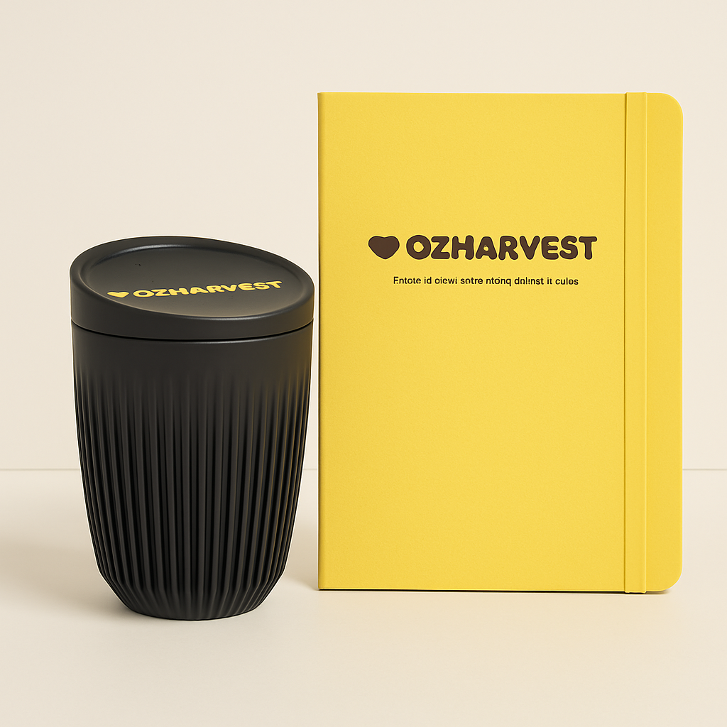 Black textured tumbler and yellow notebook with 'OZHarvest' branding on a beige background