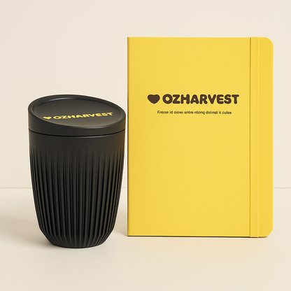 Black textured tumbler and yellow notebook with 'OZHarvest' branding on a beige background