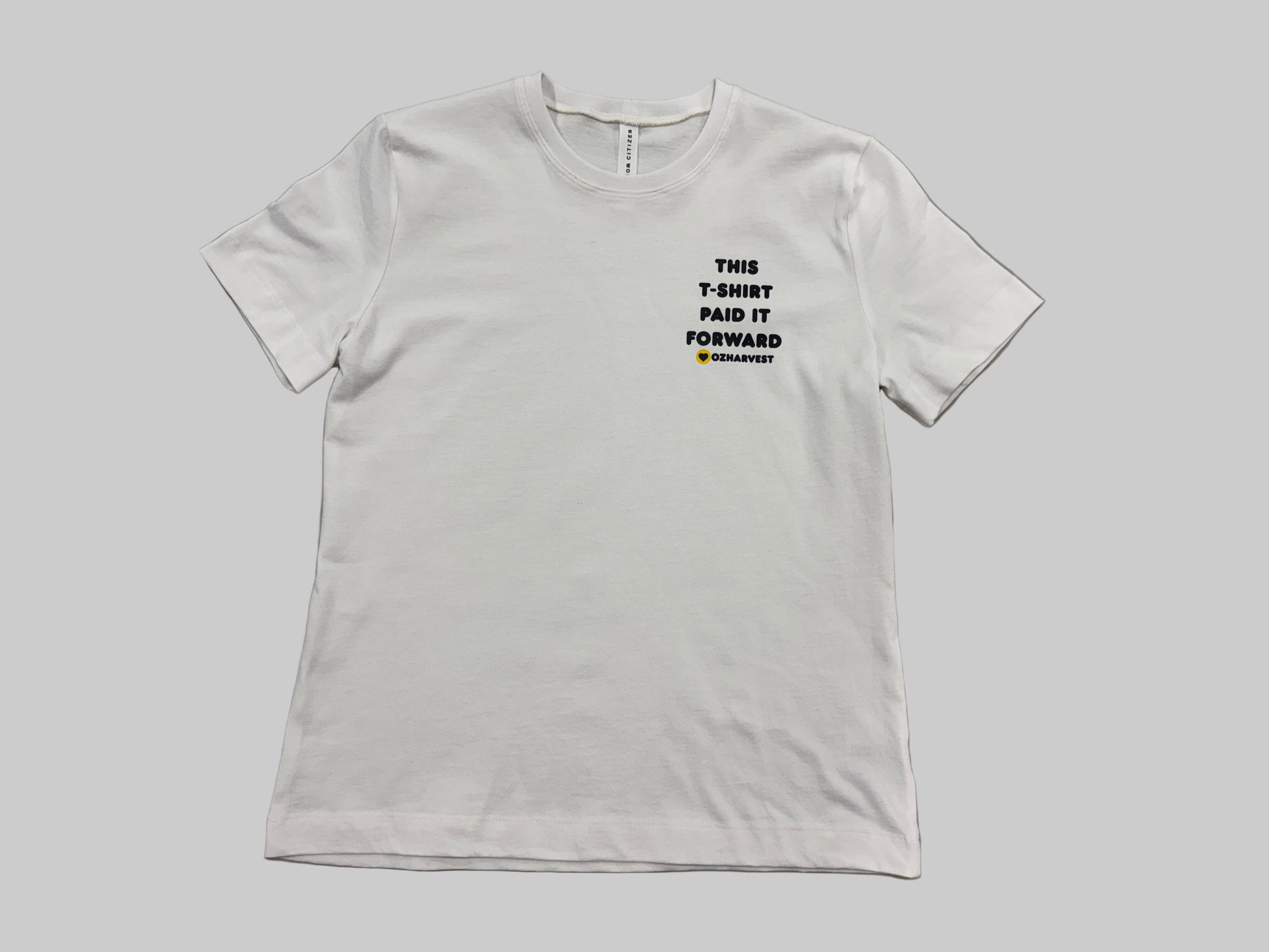 White t-shirt with Paid It Forward