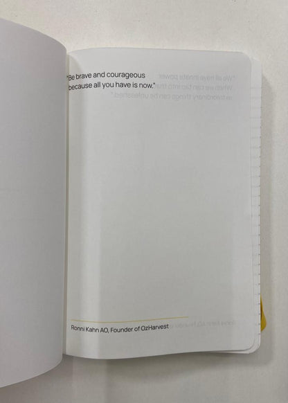 Open book with a quote on a white background